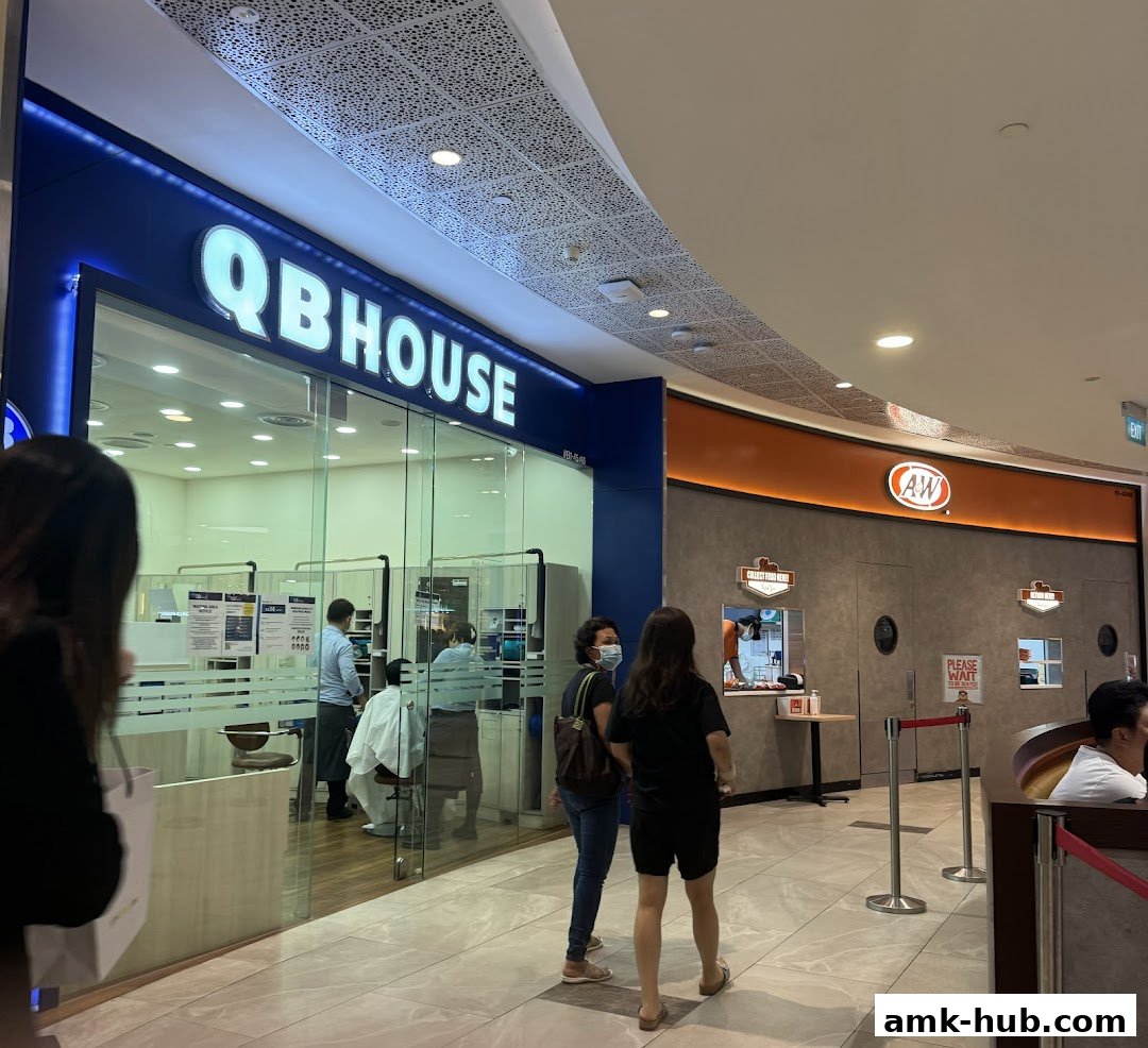 The exterior of a QB HOUSE salon with customers inside and an A&W restaurant next door.