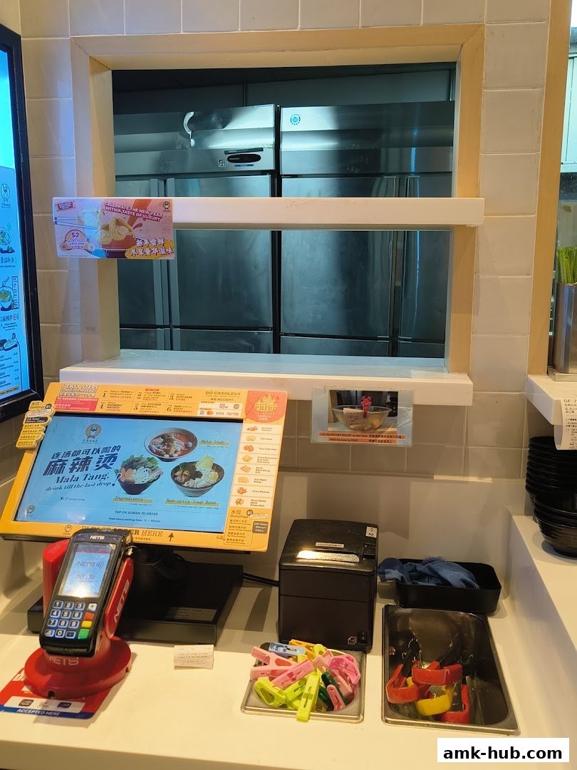 A counter display for ordering Mala Tang with a touchscreen, payment terminal, and receipt printer.