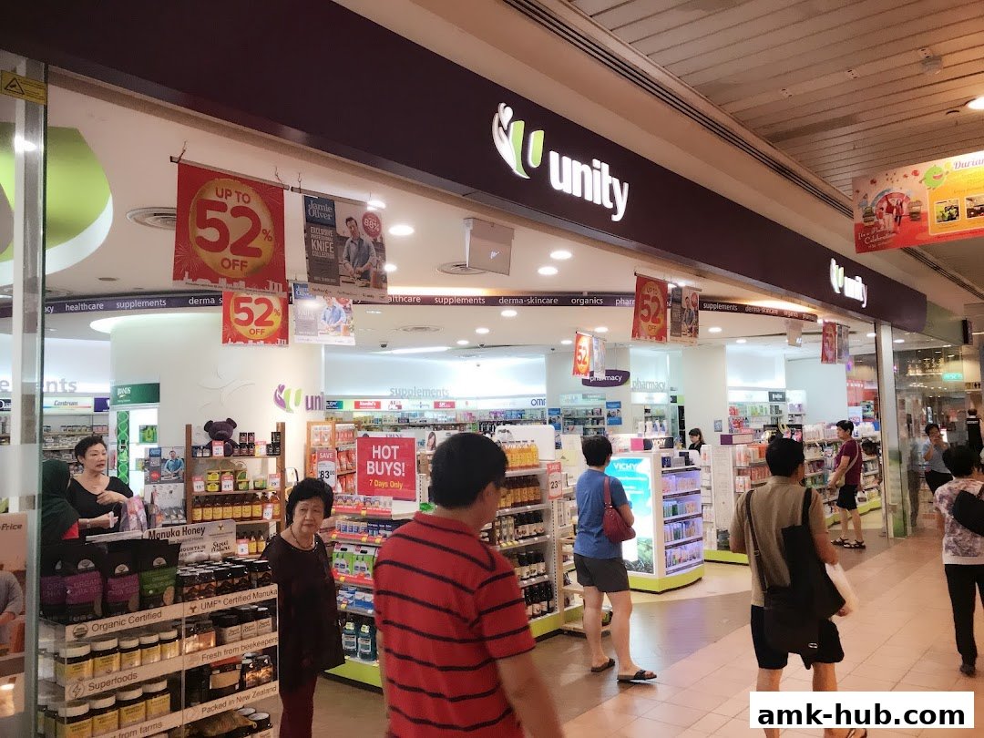 The Unity pharmacy and health store features a prominent sign and displays of health products and promotions.