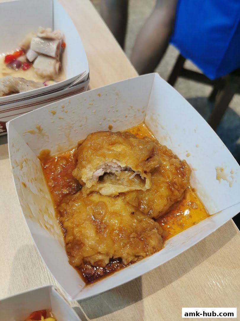 Close-up of delicious dim sum dishes served in white paper containers.