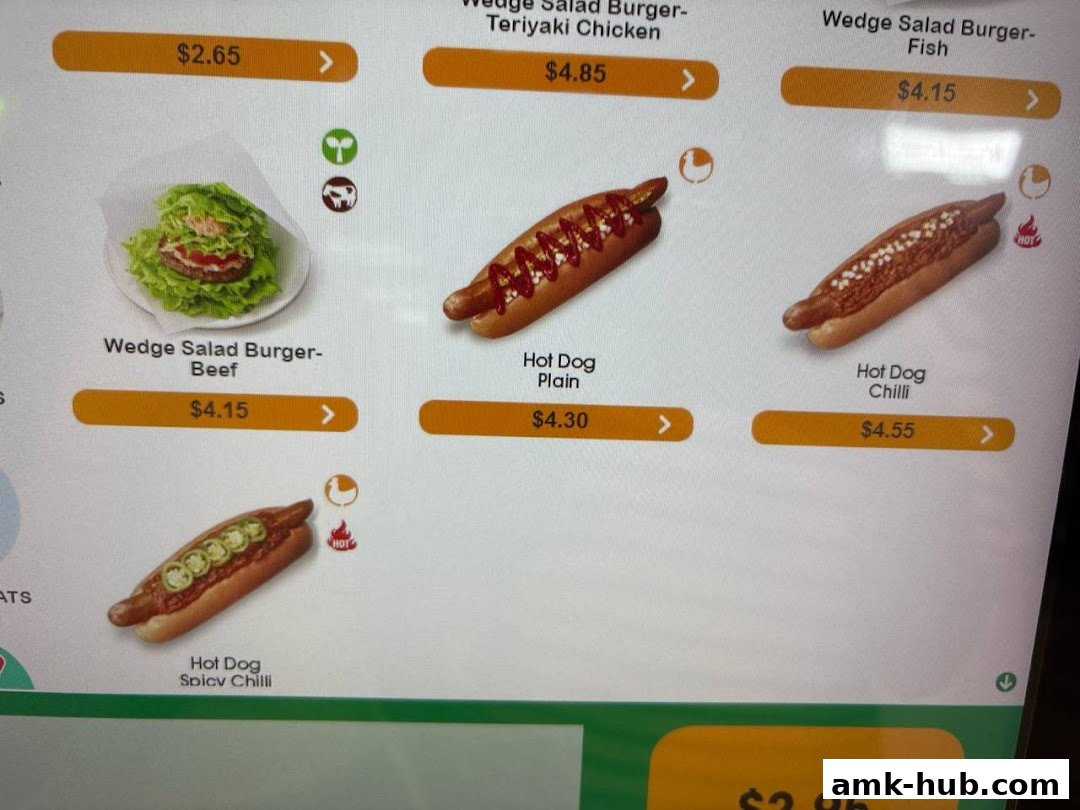 A digital menu displaying various burgers and hot dogs with prices.