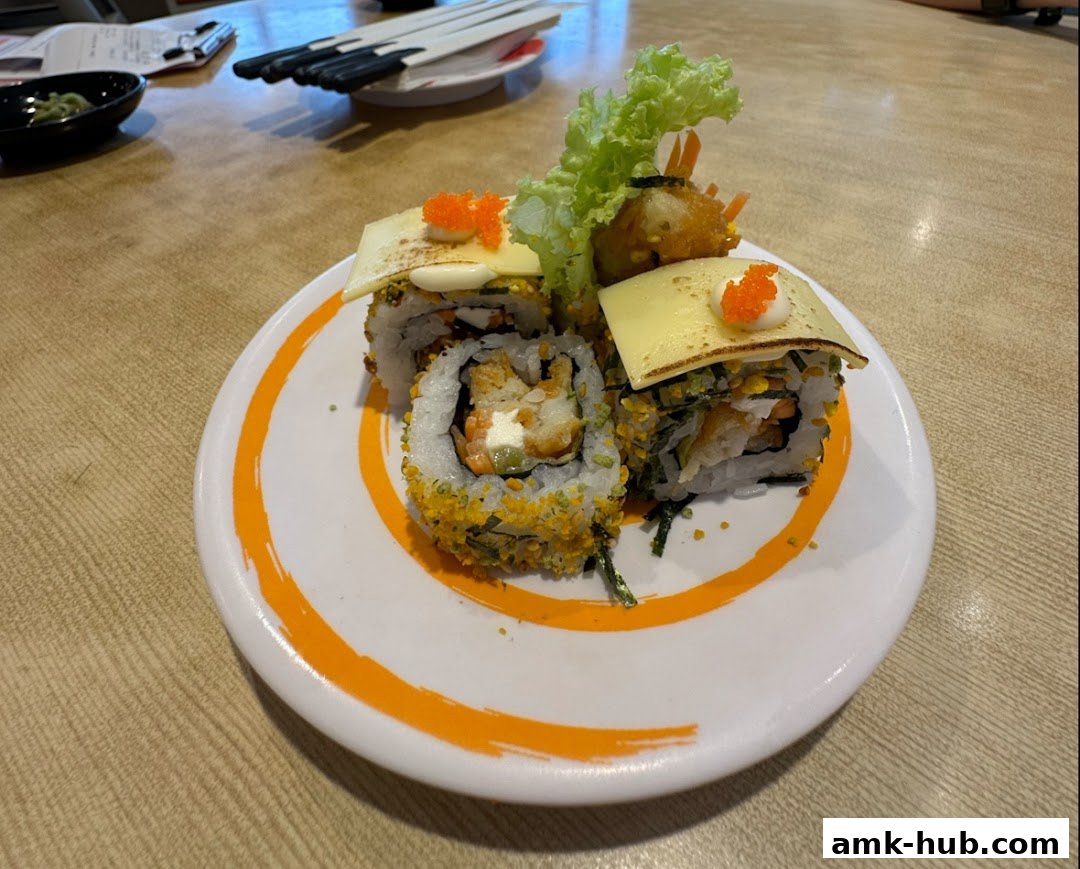 A plate of sushi rolls with cheese, lettuce, and roe, served on a wooden table.
