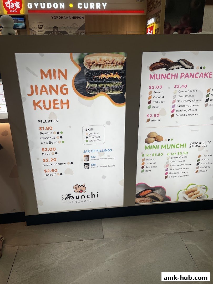 A menu board for Munchi Pancakes, showcasing Min Jiang Kueh and Mini Munchi options with various fillings.
