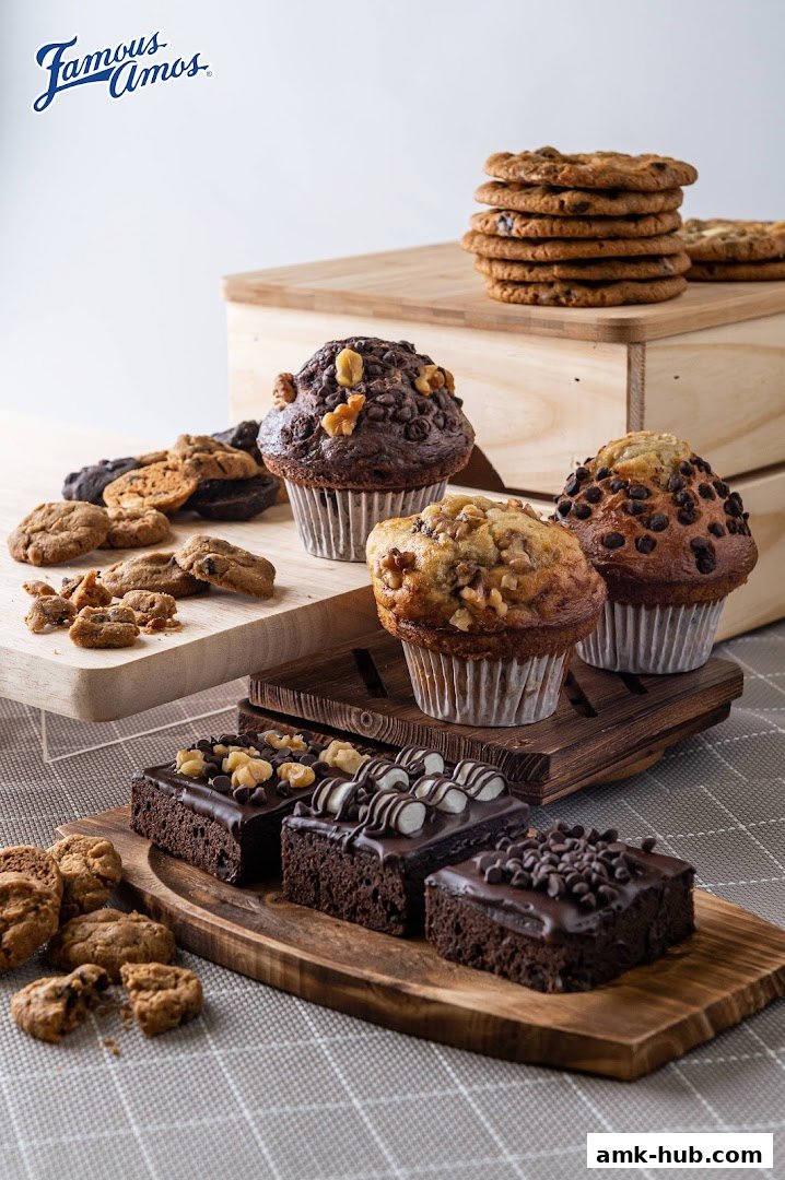 A delightful assortment of Famous Amos cookies, muffins, and brownies arranged attractively.