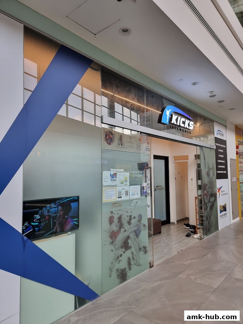 The entrance to Kicks Taekwondo, featuring a modern storefront with frosted glass and Taekwondo graphics.