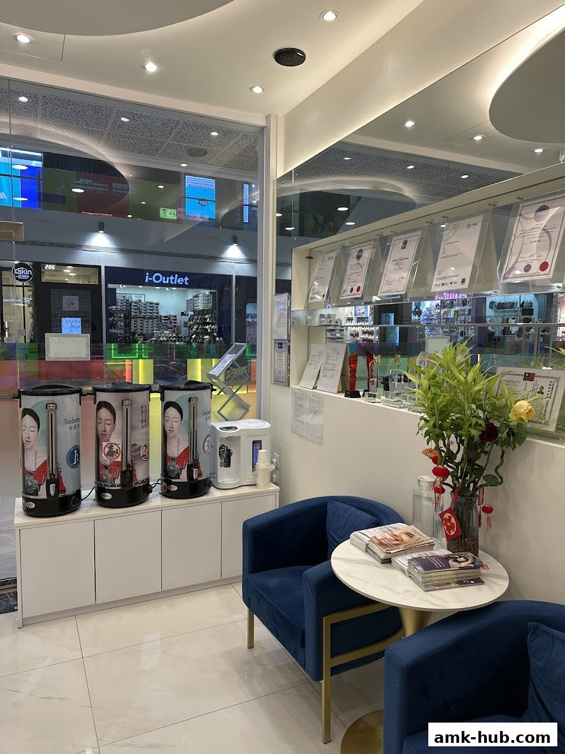 Interior of a modern beauty salon with comfortable seating and display of certifications.