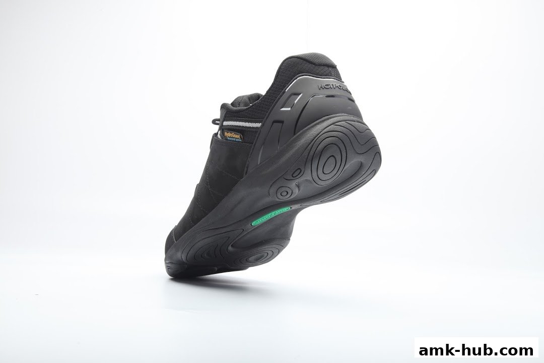 A black shoe with a white background, showcasing its sole and branding.