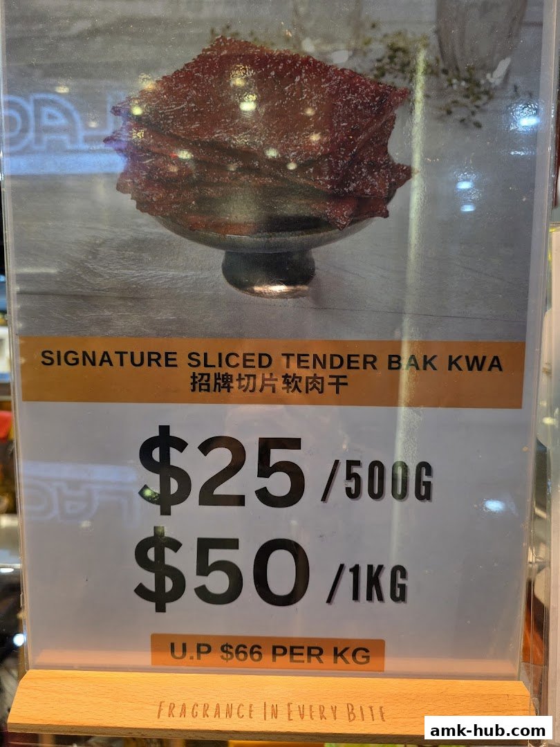A sign displays prices for Signature Sliced Tender Bak Kwa, with options for 500g and 1kg.