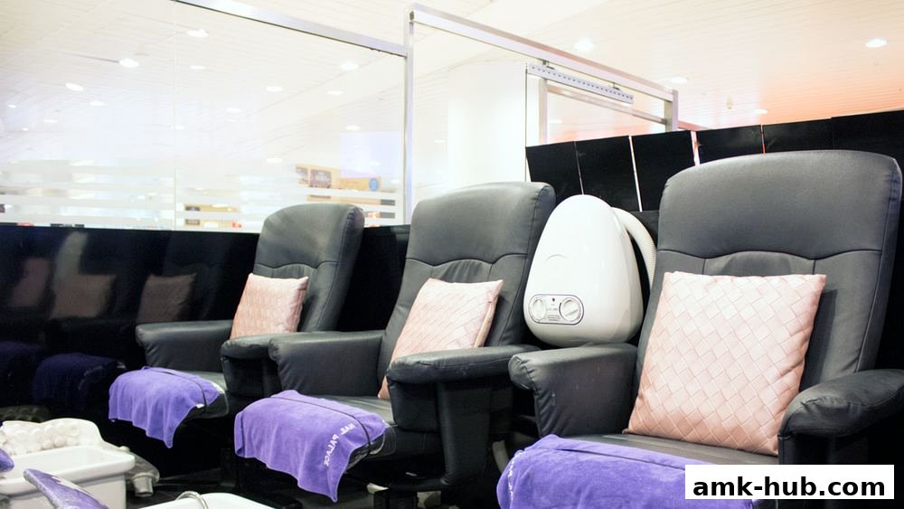 Comfortable pedicure chairs with plush cushions and purple towels at Nail Palace.