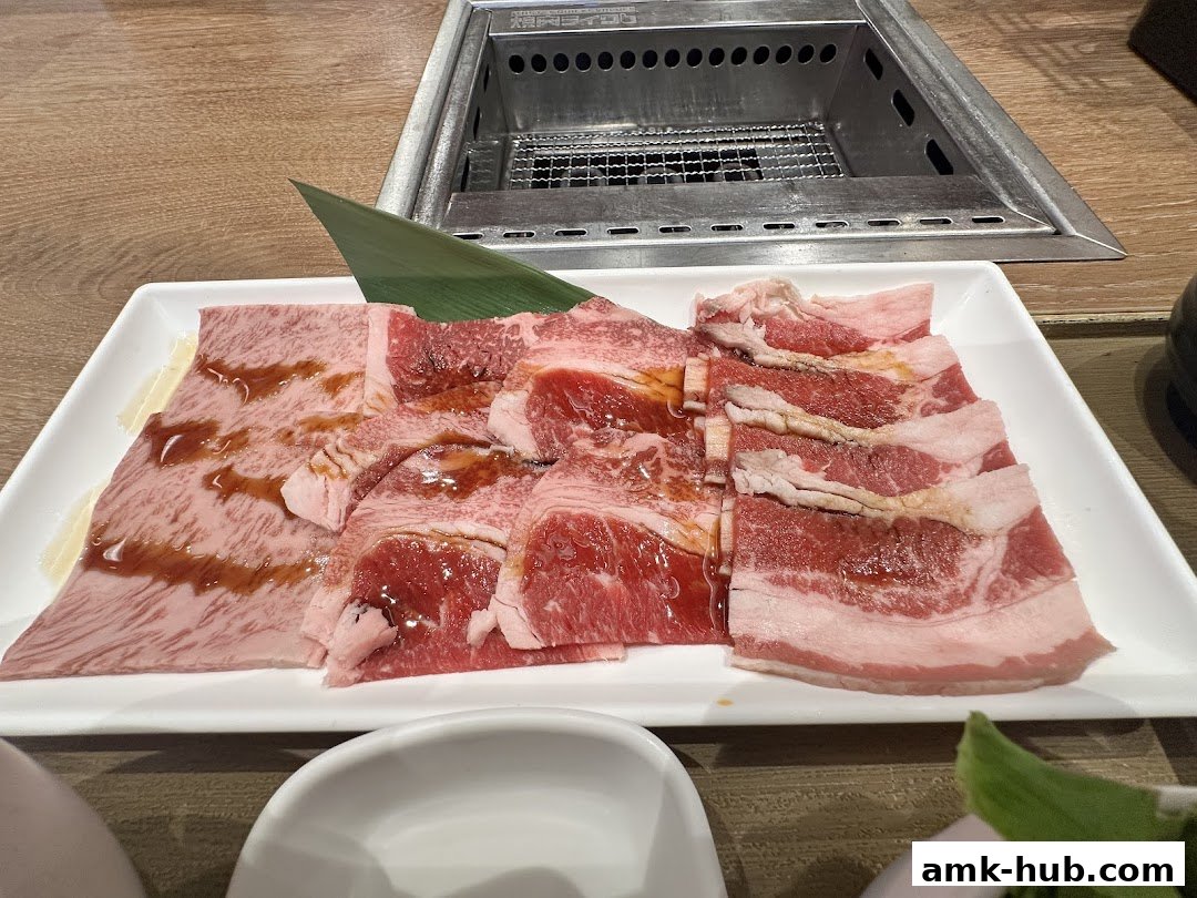 A plate of thinly sliced raw beef, seasoned with sauce, ready for grilling.