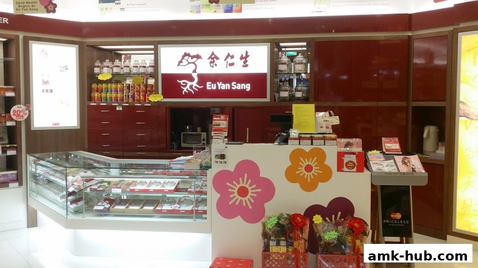The interior of a Eu Yan Sang shop, showcasing a counter, display cases with products, and branding.