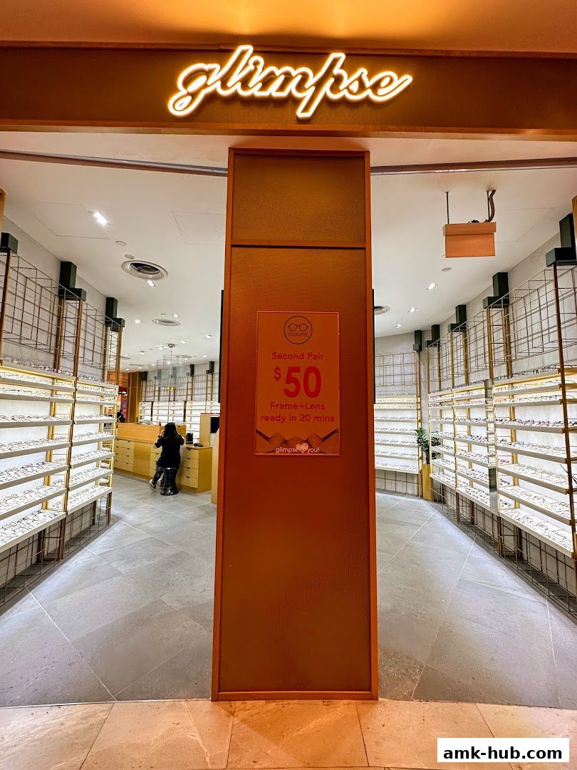 The entrance to Glimpse, an optical shop, showcasing shelves of eyeglasses and a special offer sign.