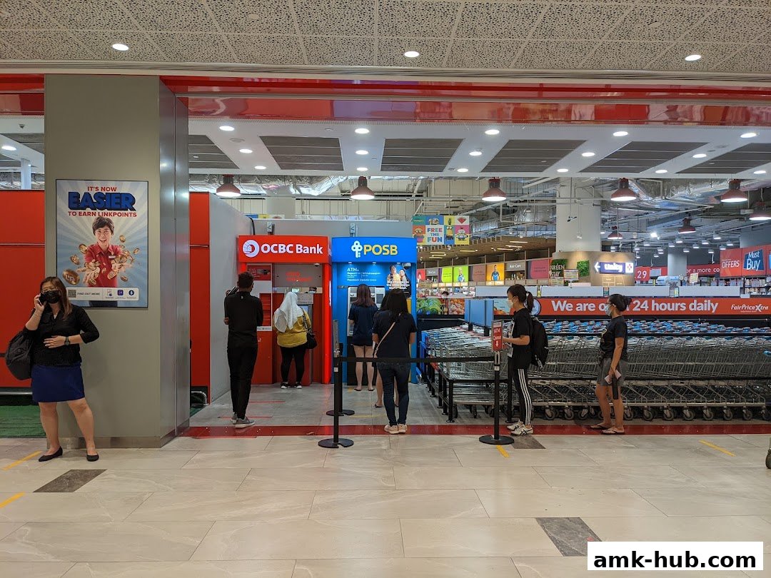 People queue at OCBC and POSB ATMs inside a FairPrice Xtra supermarket.
