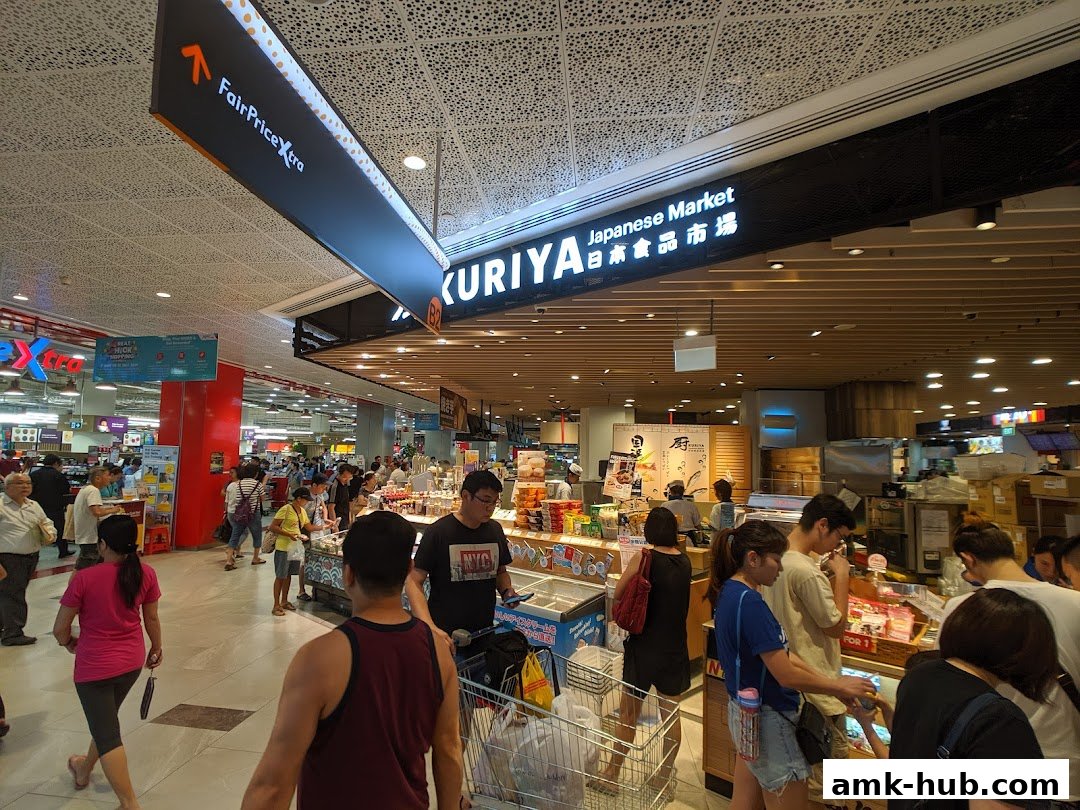 People shopping at Kuriya Japanese Market, with signage visible.
