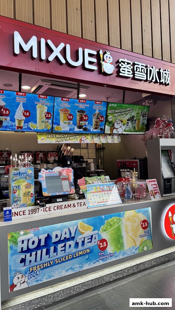 A Mixue ice cream and tea shop counter with digital menus displaying various drinks and ice cream.