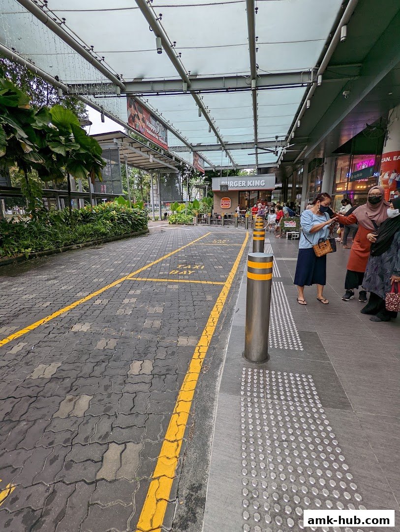 Exterior view of a Burger King restaurant with a taxi stand in front.