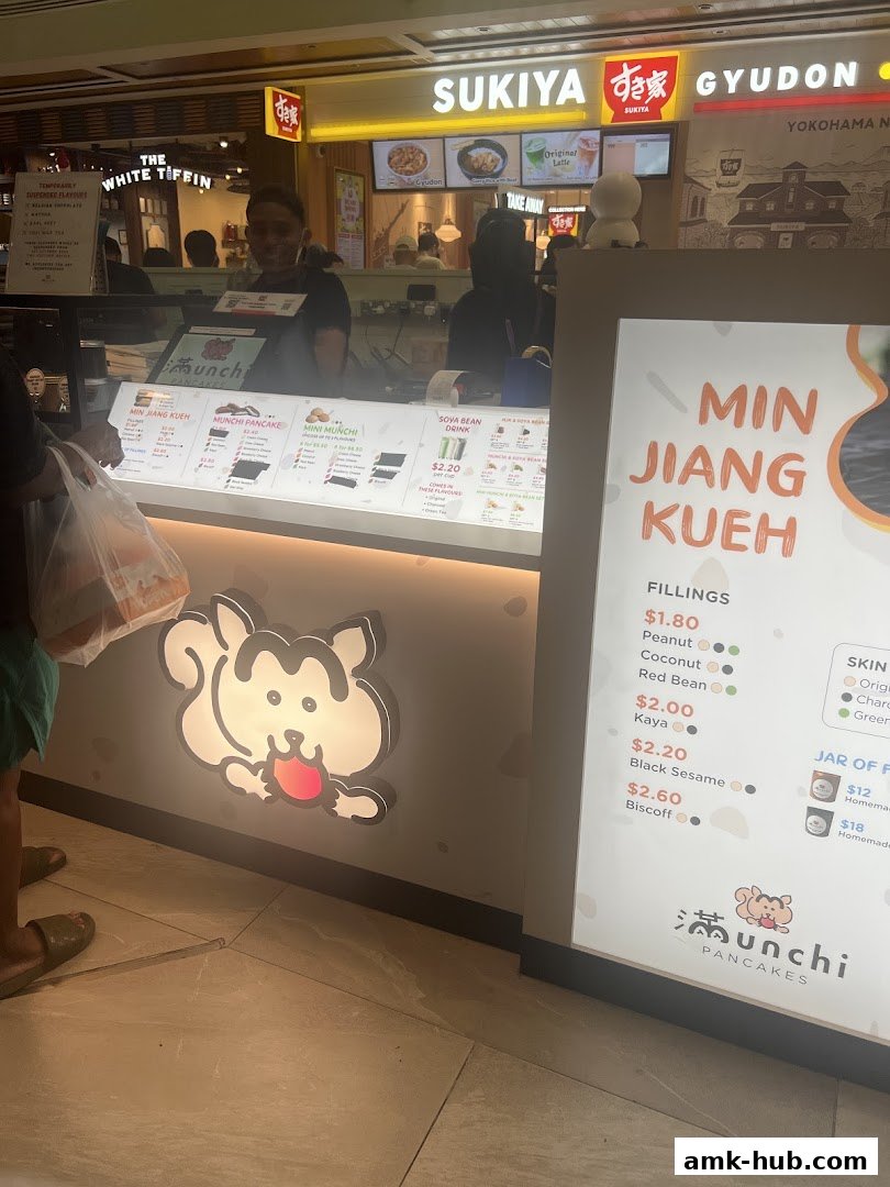 A display board for Munchi Pancakes showing various fillings and prices for Min Jiang Kueh.