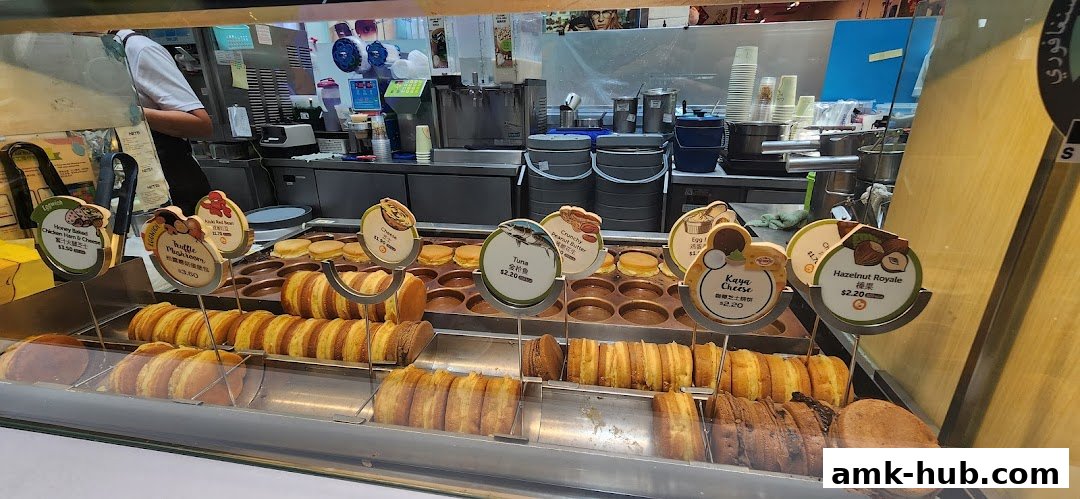 A display of freshly made, round pastries with various fillings at a food stall.