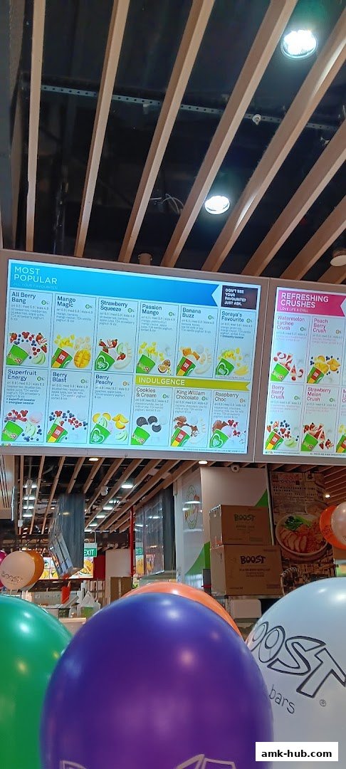 A digital menu board displaying various smoothies and juices at Boost Juice.