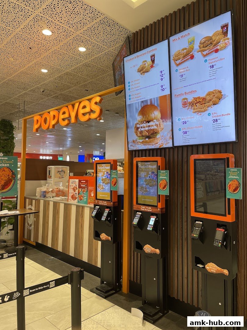 The Popeyes restaurant entrance with digital menus and self-order kiosks.