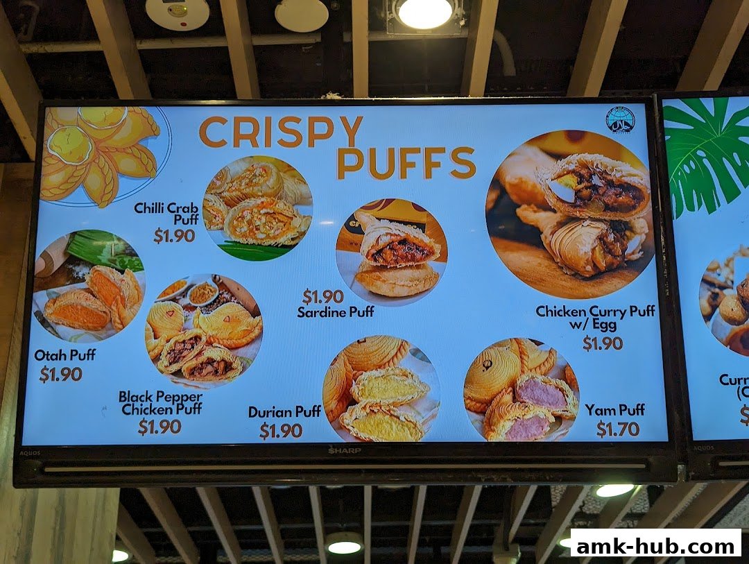 A digital menu board displaying various crispy puffs with their names and prices.