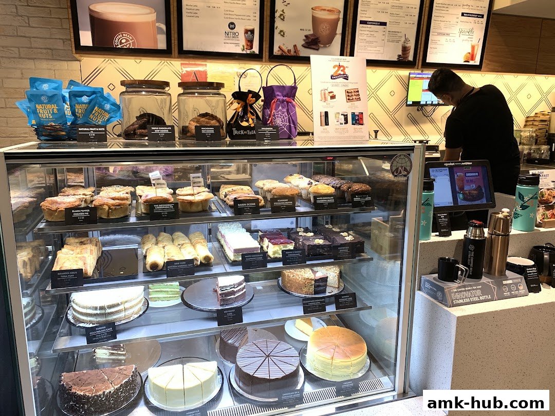 A display case filled with various cakes, pastries, and savory pies at The Coffee Bean and Tea Leaf.