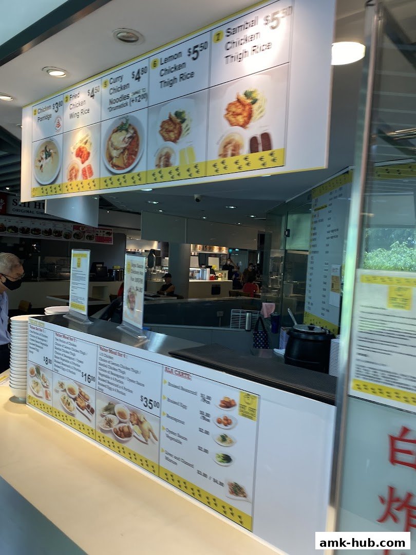 A food stall menu displaying various chicken rice dishes and side orders.