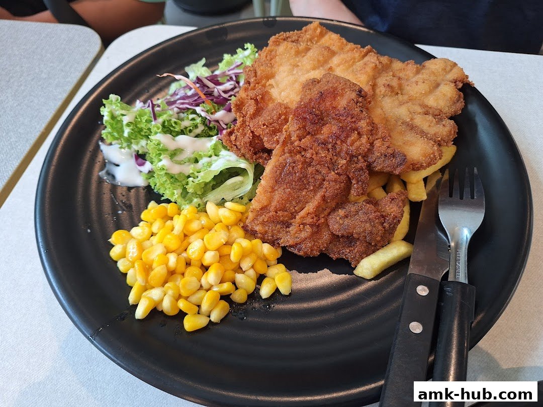 A plate of fried chicken, fries, corn, and salad with dressing.
