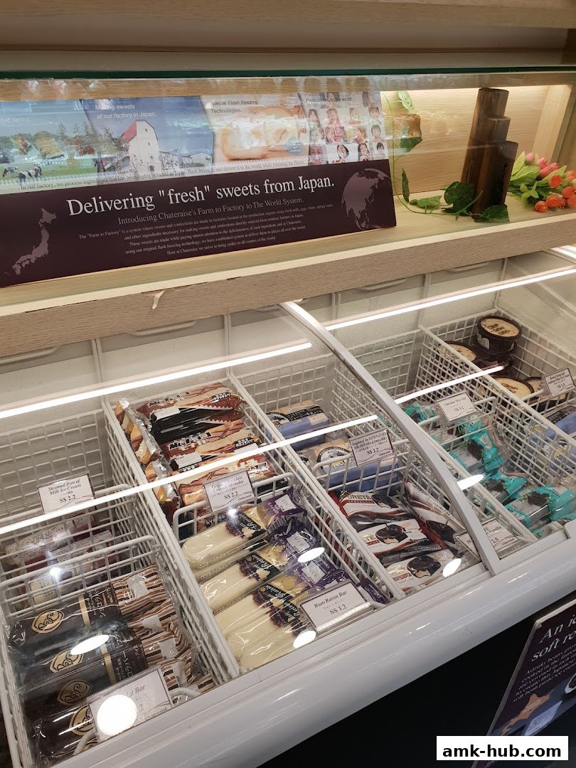 A display freezer filled with various individually packaged ice cream bars and desserts from Chateraise.