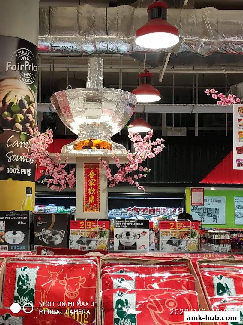 A display of cookware and festive decorations, likely in a supermarket.