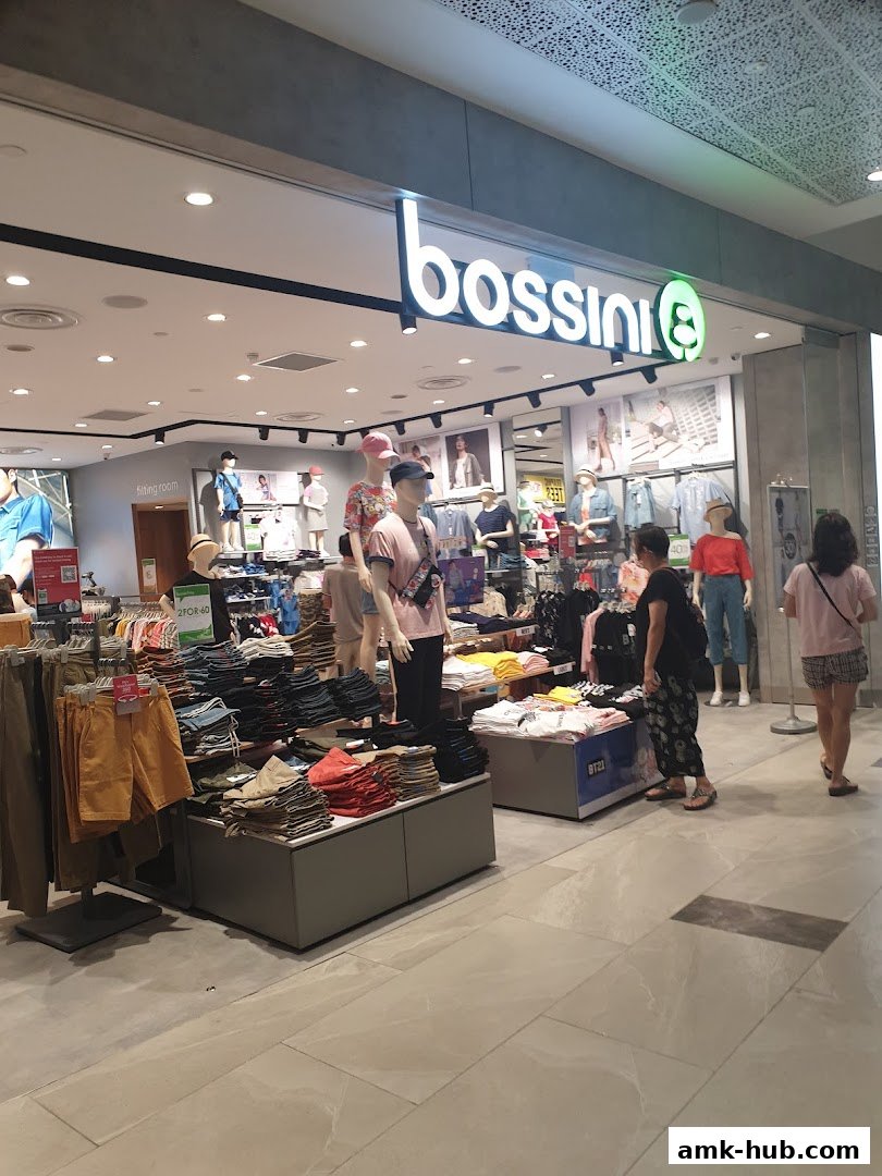 The Bossini store displays a variety of casual clothing on mannequins and shelves.