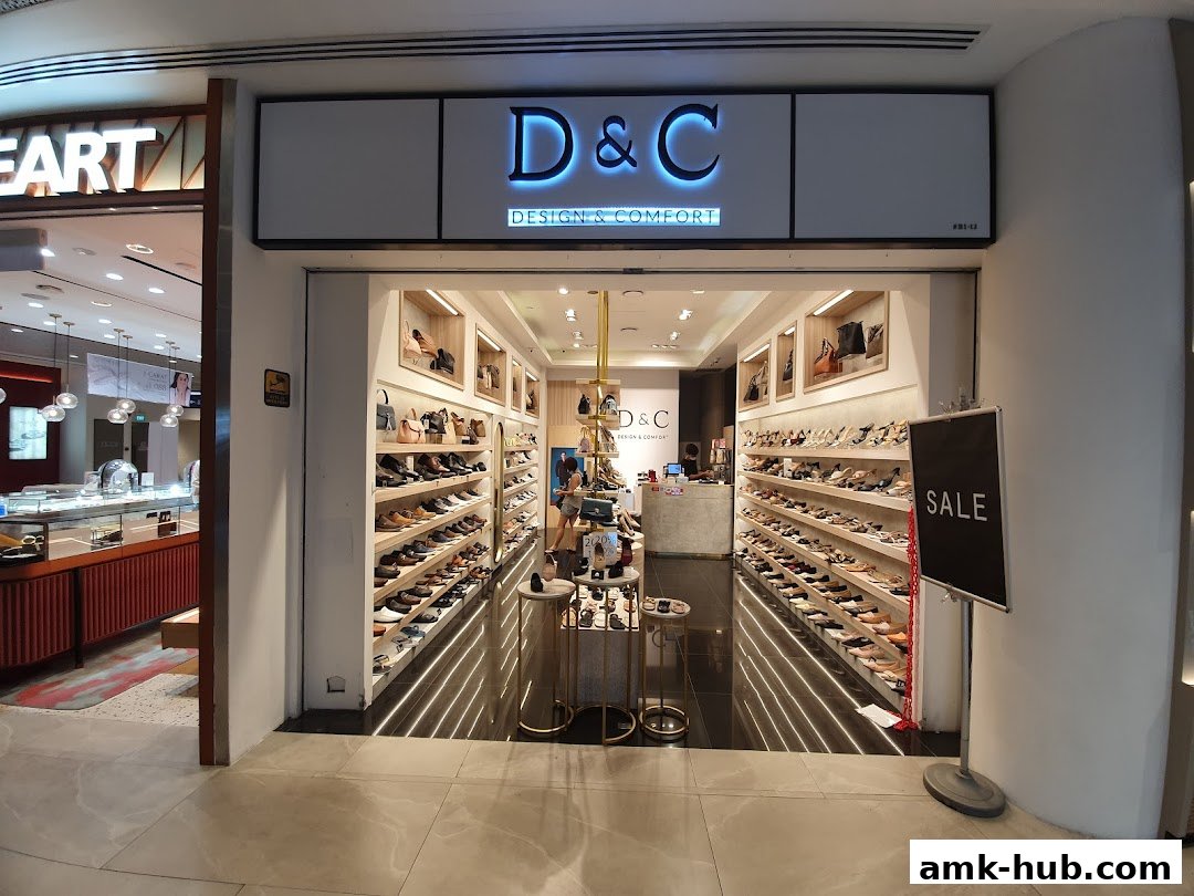 The entrance of a shoe store named D&C, showcasing a wide selection of footwear.