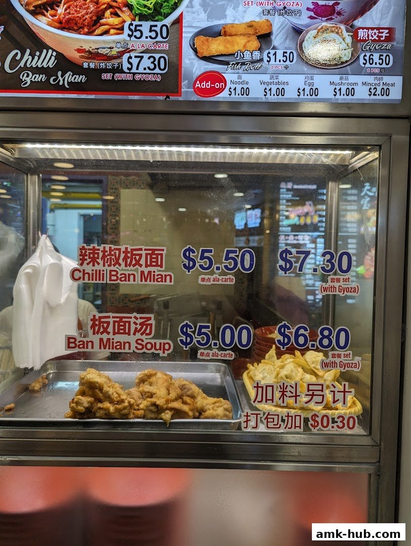A food stall menu displaying various Ban Mian dishes and add-ons with prices.