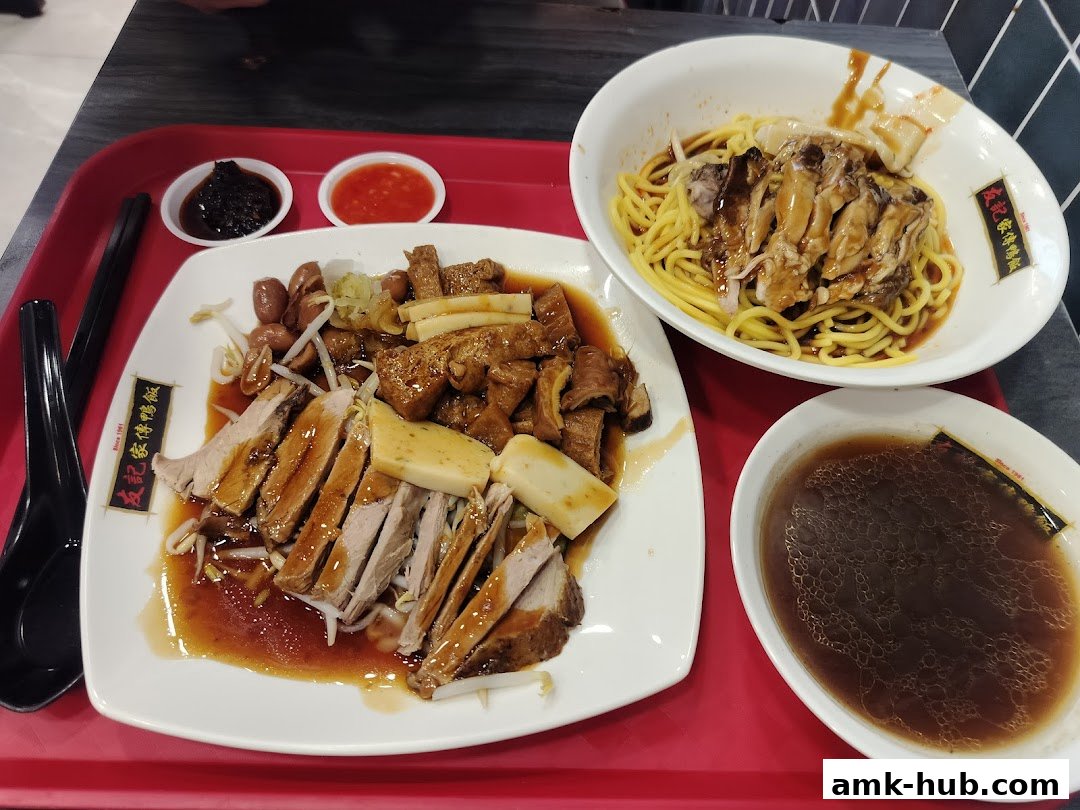A tray of delicious food from Yew Kee Specialities, featuring sliced meats, noodles, and soup.