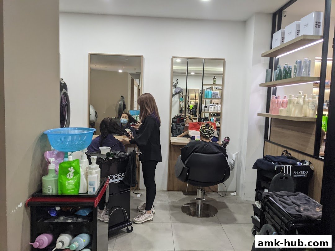 Hair salon interior with stylists attending to clients and shelves stocked with hair products.