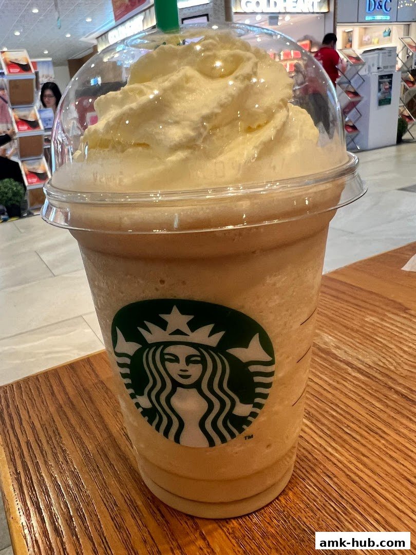 A close-up of a Starbucks Frappuccino topped with whipped cream.