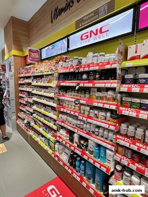 Shelves stocked with vitamins, supplements, and health products at Watsons GNC.