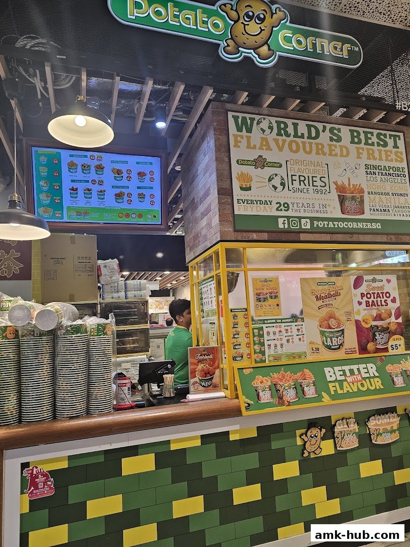 A Potato Corner shop counter with a menu board, staff, and various food items displayed.