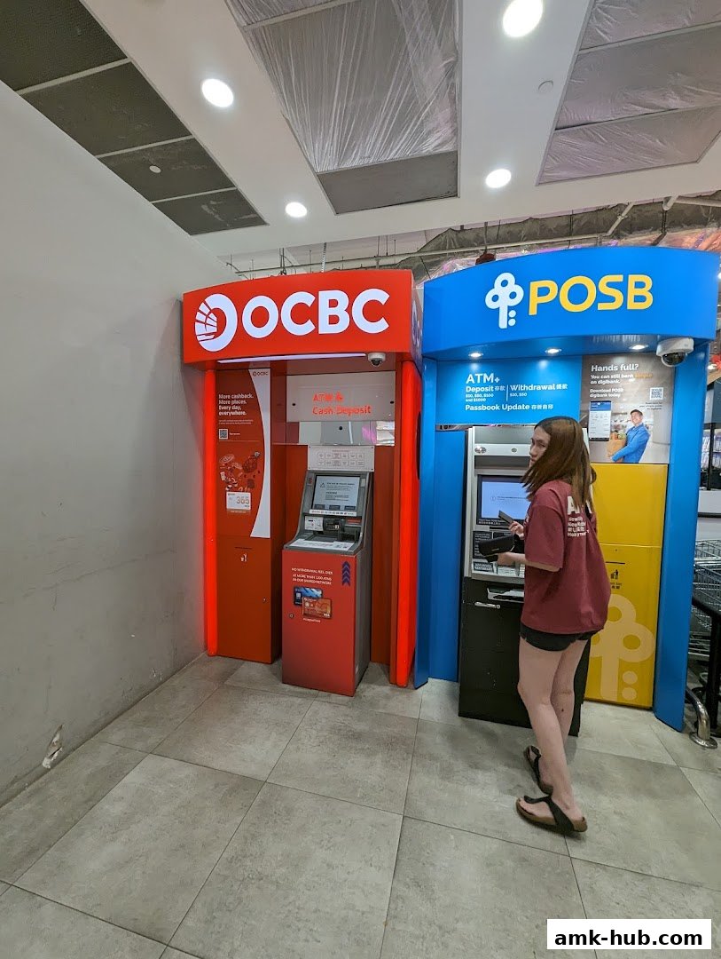 An OCBC ATM and a POSB ATM are shown side-by-side, with a person using the POSB ATM.