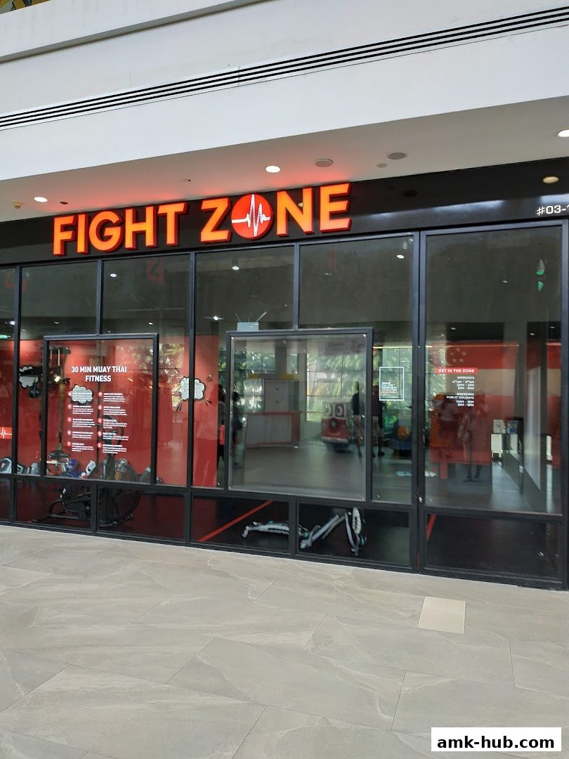 The exterior of the Fight Zone gym, featuring its prominent signage and large glass windows.