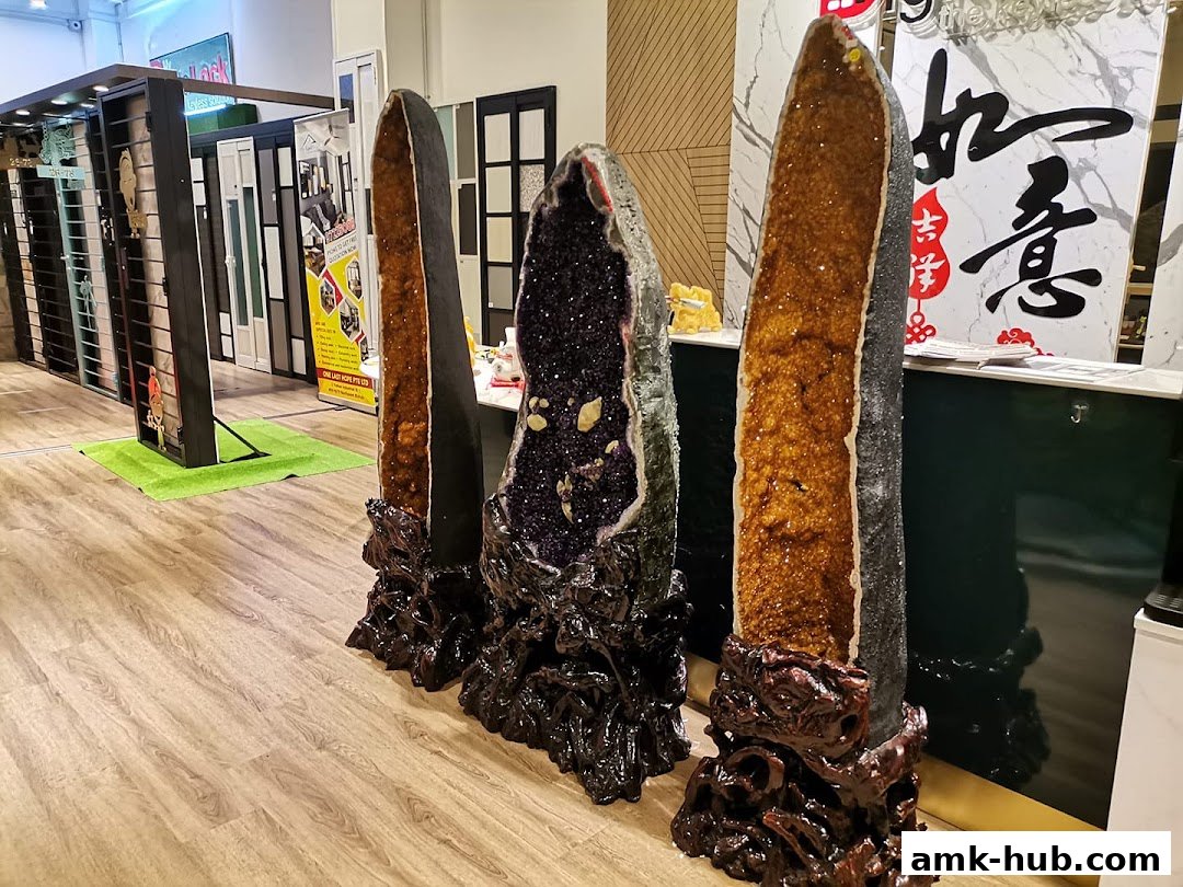 Large crystal geodes displayed in a shop with doors and signage in the background.