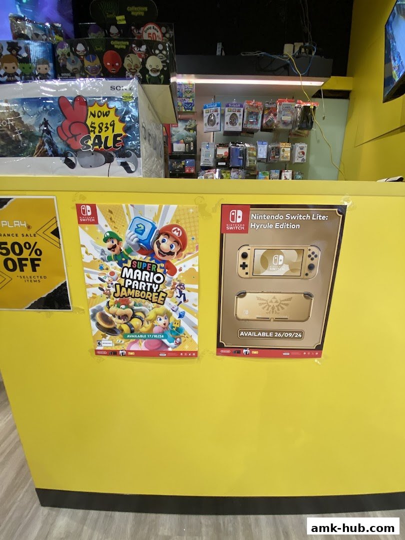A bright yellow counter displays gaming posters and merchandise, with a sale sign visible.
