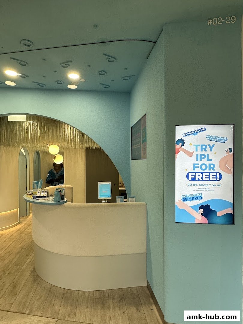 Interior of a modern beauty salon with a reception desk and promotional poster.