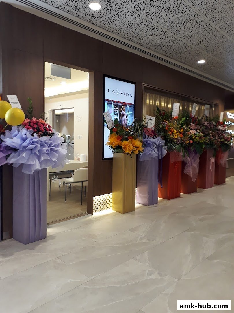 The entrance of La Vida shop at AMK Hub, decorated with flowers and balloons.