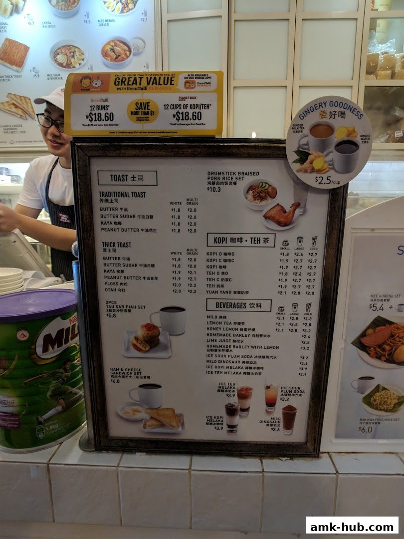 A menu board for Toast Box AMK Hub, featuring traditional and thick toast, drinks, and meal sets.