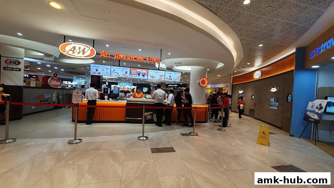 A&W restaurant counter with customers queuing and menu boards displayed above.