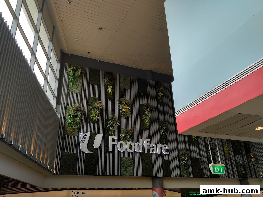A modern wall with vertical greenery and the 'Foodfare' logo, alongside an 'EXIT' sign.