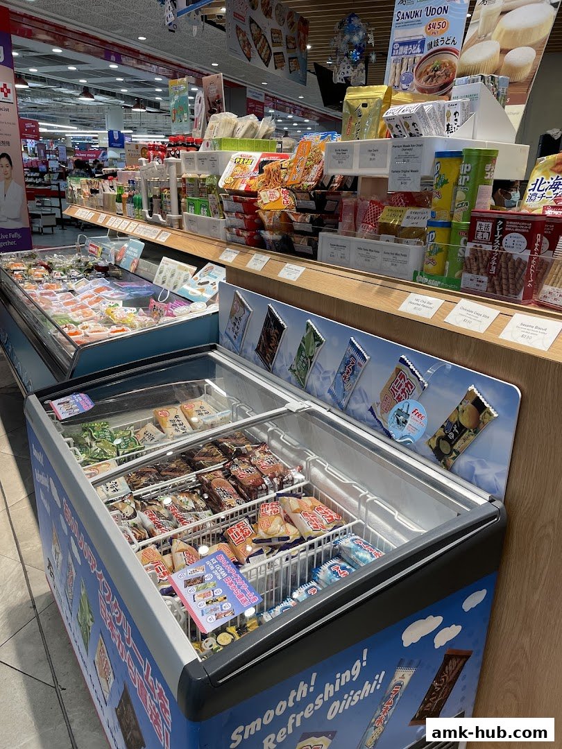 A display of Japanese food products including frozen items, snacks, and instant noodles.