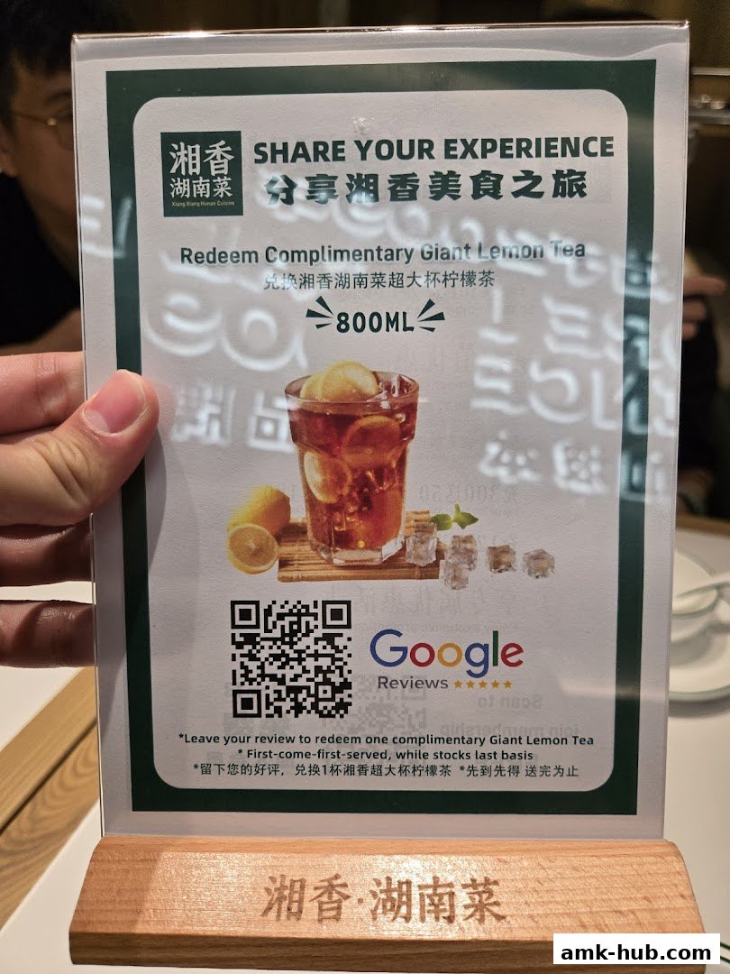 A promotional sign for Xiang Xiang Hunan Cuisine offering a complimentary giant lemon tea.