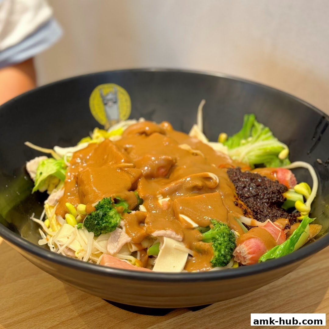 A close-up of a bowl of Mala Tang with various ingredients and a rich sauce.
